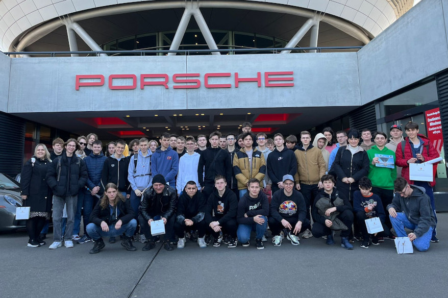 Zdjecie grupowe uczniów przed budynkiem z napisem Porsche
