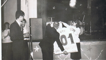 zdjęcie ze Studniówki, na którym Urszula Oleś razem z ówczesnym dyrektorem Śl.TZN – Stanisławem Kubicą – zrywa kartkę z kalendarza na 100 dni przed maturą 1979