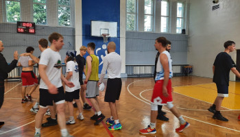 Zawodnicy: uczniowie, absolwenci, nauczyciele wf podczas powitania na rozpoczęcie meczu koszykówki w Śl.TZN