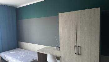 Pokój gościnny – wyposażony w biurko z krzesłem oraz szafę do przechowywania rzeczy osobistych.