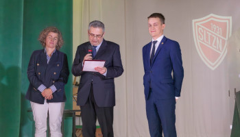 Na scenie: Pan Dyrektor odczytuje o wyróżnieniu „Złotą Tarczą”, z lewej Pani Przewodnicząca Rady Rodziców, z prawej nagradzany Absolwent