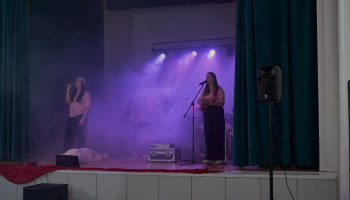 Występ - dwie wokalistki na scenie podczas występu, po lewej śpiewa, po prawej – śpiewa i akompaniuje na ukulele